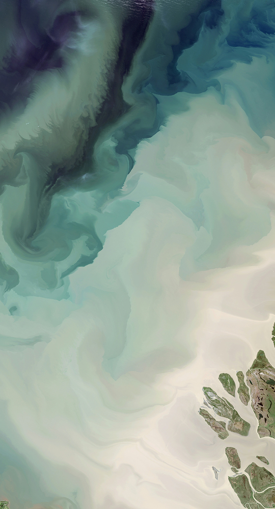 Swirling abstract aerial scene with teal, green, and cream tones; dark plume at upper left, light sandy area at lower right, hints of rocky coastline.