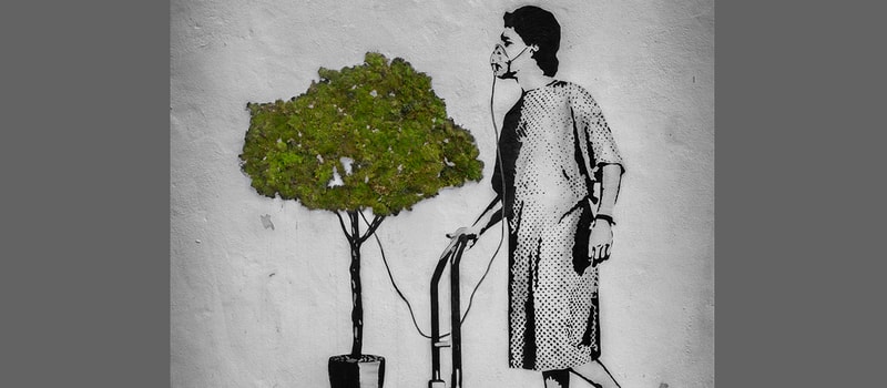 A black-and-white mural shows a woman in a dotted dress beside a potted tree, holding a phone to her ear while standing next to a luggage cart.