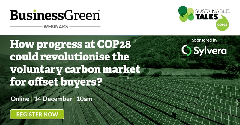 A promotional banner for BusinessGreen Webinars featuring a green solar farm background, bold white headline about COP28 progress, sponsor logo Sylvera, and a prominent REGISTER NOW button.