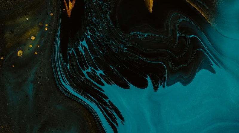 Swirling teal and black liquid patterns with bright turquoise streaks and golden speckles across a dark, abstract fluid surface.
