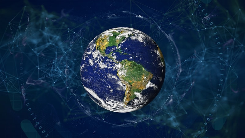 Earth seen from space at center, with swirling white clouds and green continents, surrounded by digital network lines and abstract data patterns in blue.