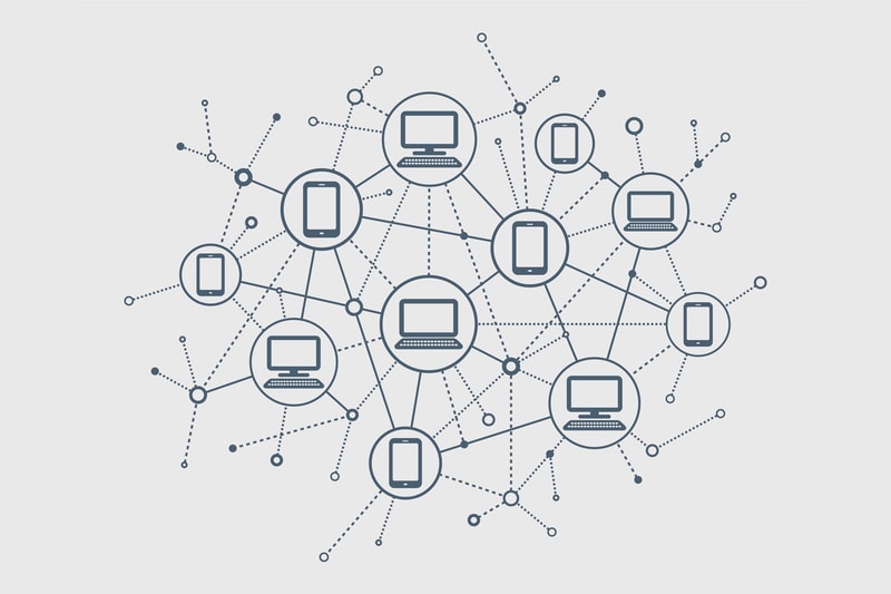 A network diagram of interconnected devices, featuring multiple circular hubs containing laptops, tablets, and phones connected by dotted and solid lines.