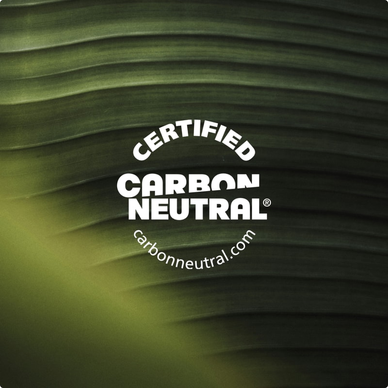 Certified Carbon Neutral logo overlay on a dark green leaf background with curved text "CERTIFIED CARBON NEUTRAL" and website carbonneutral.com.