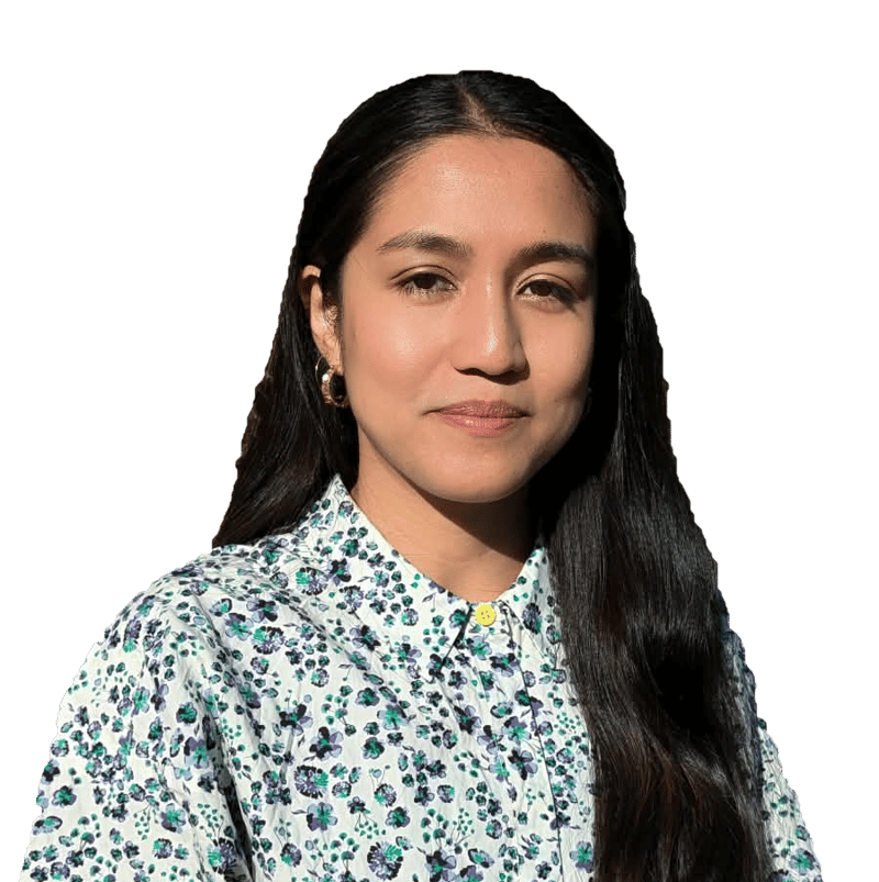 woman with long dark hair wearing a floral button-up shirt, neutral expression, golden hoop earring, facing slightly to the right against a black background